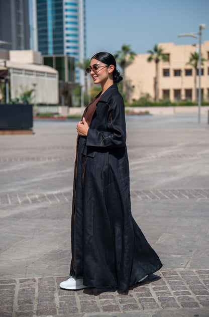 Modern black and brown linen abaya with wide lapels and structured street-style design