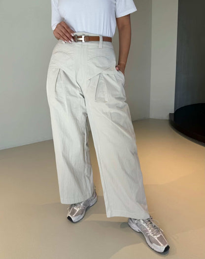 Light-colored wide-leg pleated crepe pants with a relaxed fit and elegant silhouette - The Elegant Pleated Crepe Pants