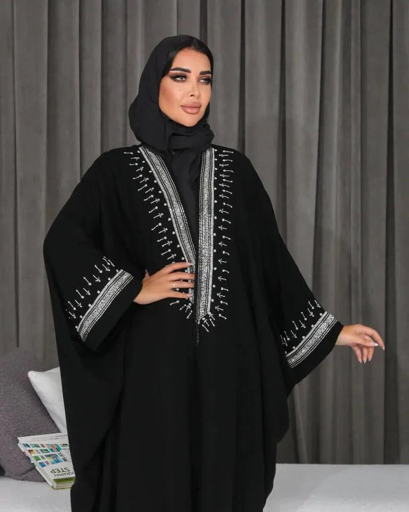 Elegant black bisht with silver hand embroidery on crepe fabric, featuring a flowing, free-size silhouette.