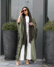 Woman wearing a free-size olive silk bisht with a soft shine over casual white and brown outfit outdoors - free-size olive bisht