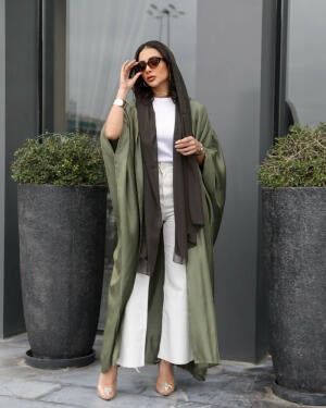Woman wearing a free-size olive silk bisht with a soft shine over casual white and brown outfit outdoors - free-size olive bisht