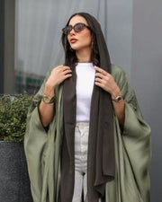 Woman wearing a free-size olive silk bisht with a soft shine over casual white and brown outfit outdoors - free-size olive bisht