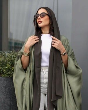 Woman wearing a free-size olive silk bisht with a soft shine over casual white and brown outfit outdoors - free-size olive bisht