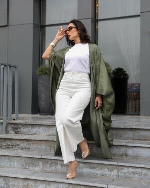 Woman wearing a free-size olive silk bisht with a soft shine over casual white and brown outfit outdoors - free-size olive bisht