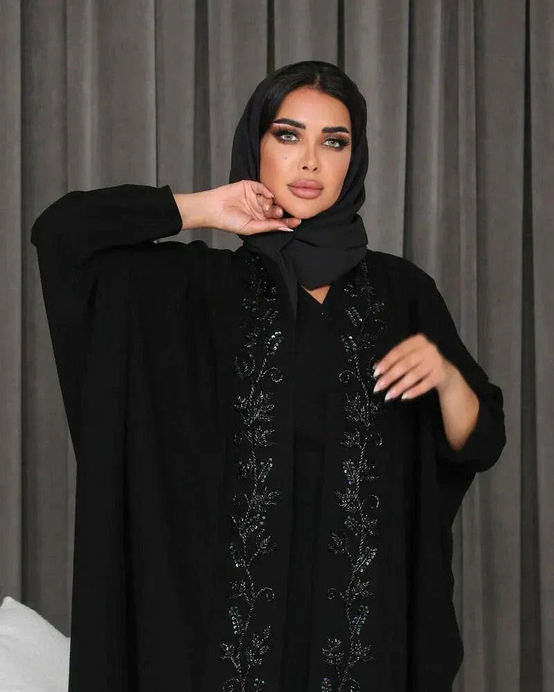 woman wearing elegant black bisht with hand embroidery in soft crepe fabric