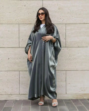 Woman wearing freesize bisht made of shimmering silver silk with a soft drape and radiant glow