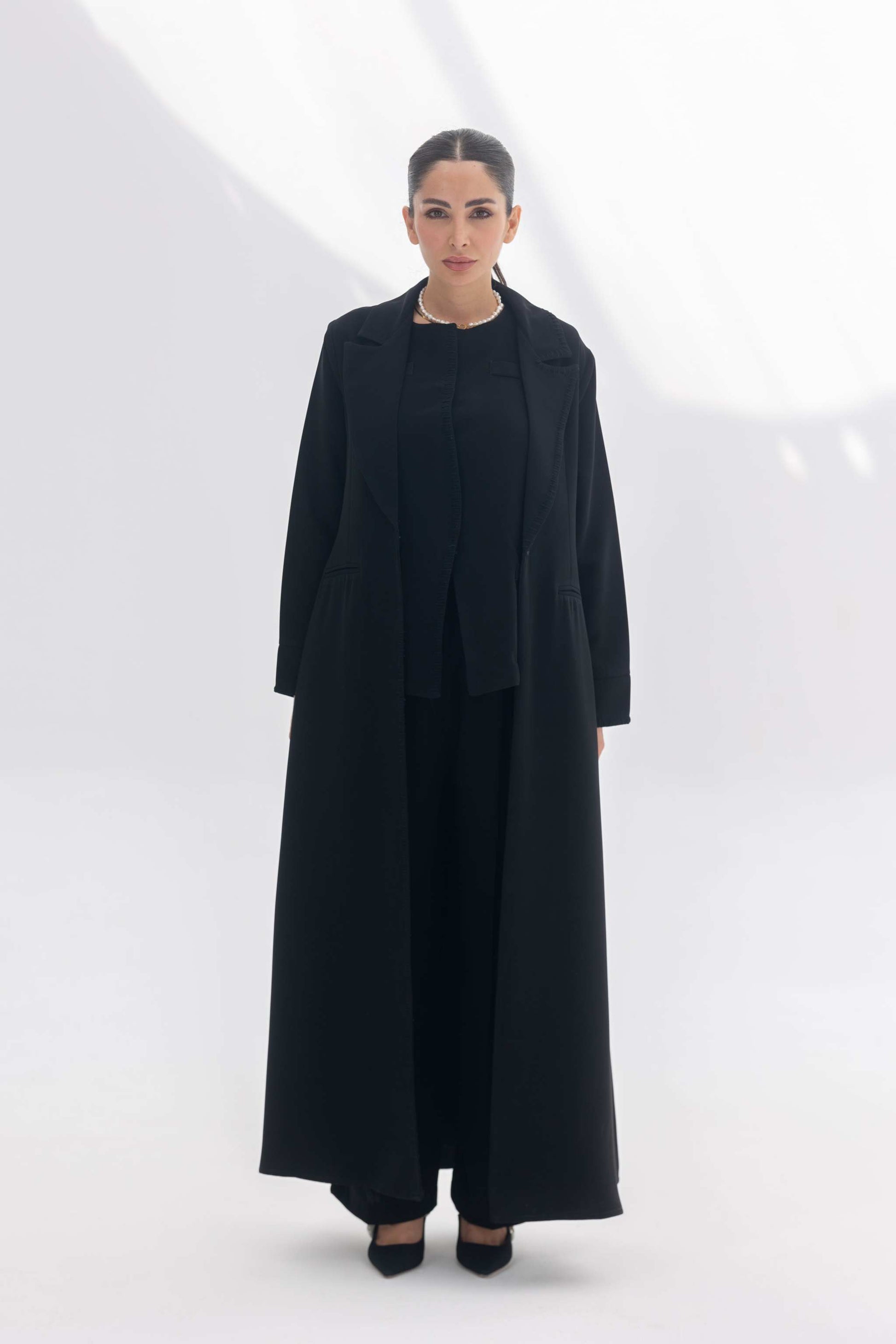 Black crepe blazer abaya with tailored silhouette and black embroidery, styled with matching inner and pants for a modern modest look.