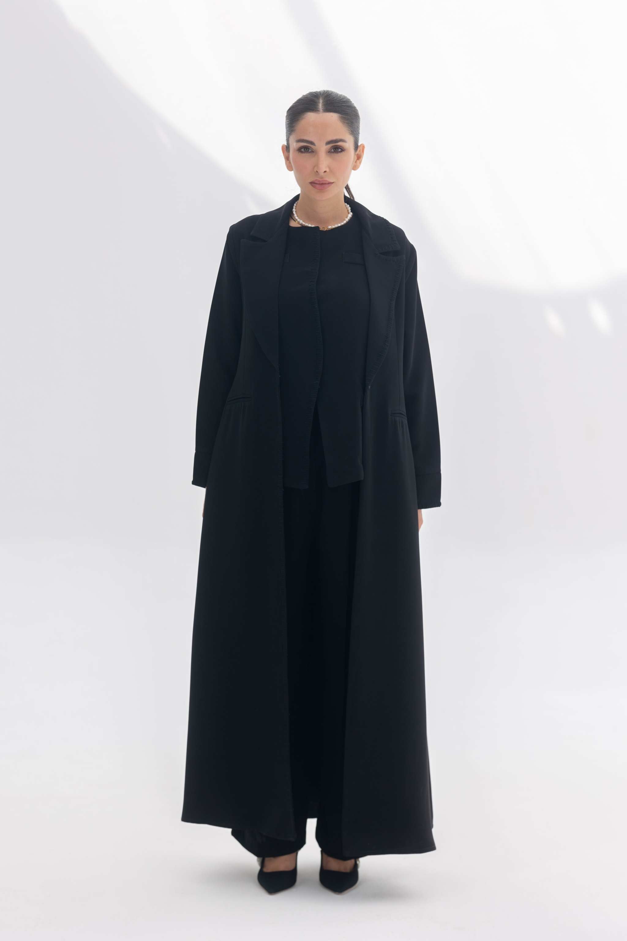Black crepe blazer abaya with tailored silhouette and black embroidery, styled with matching inner and pants for a modern modest look.