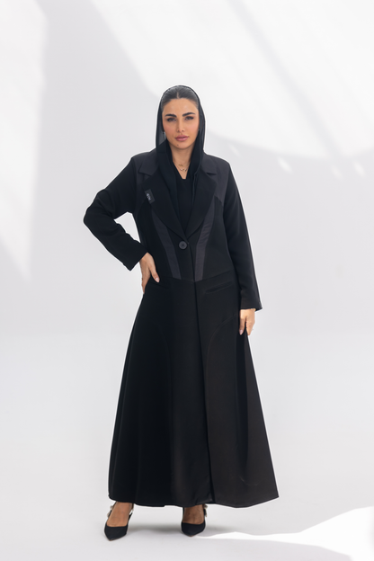 Woman wearing elegant black crepe Jetline abaya with dark grey accents and silk lining, front-open style.