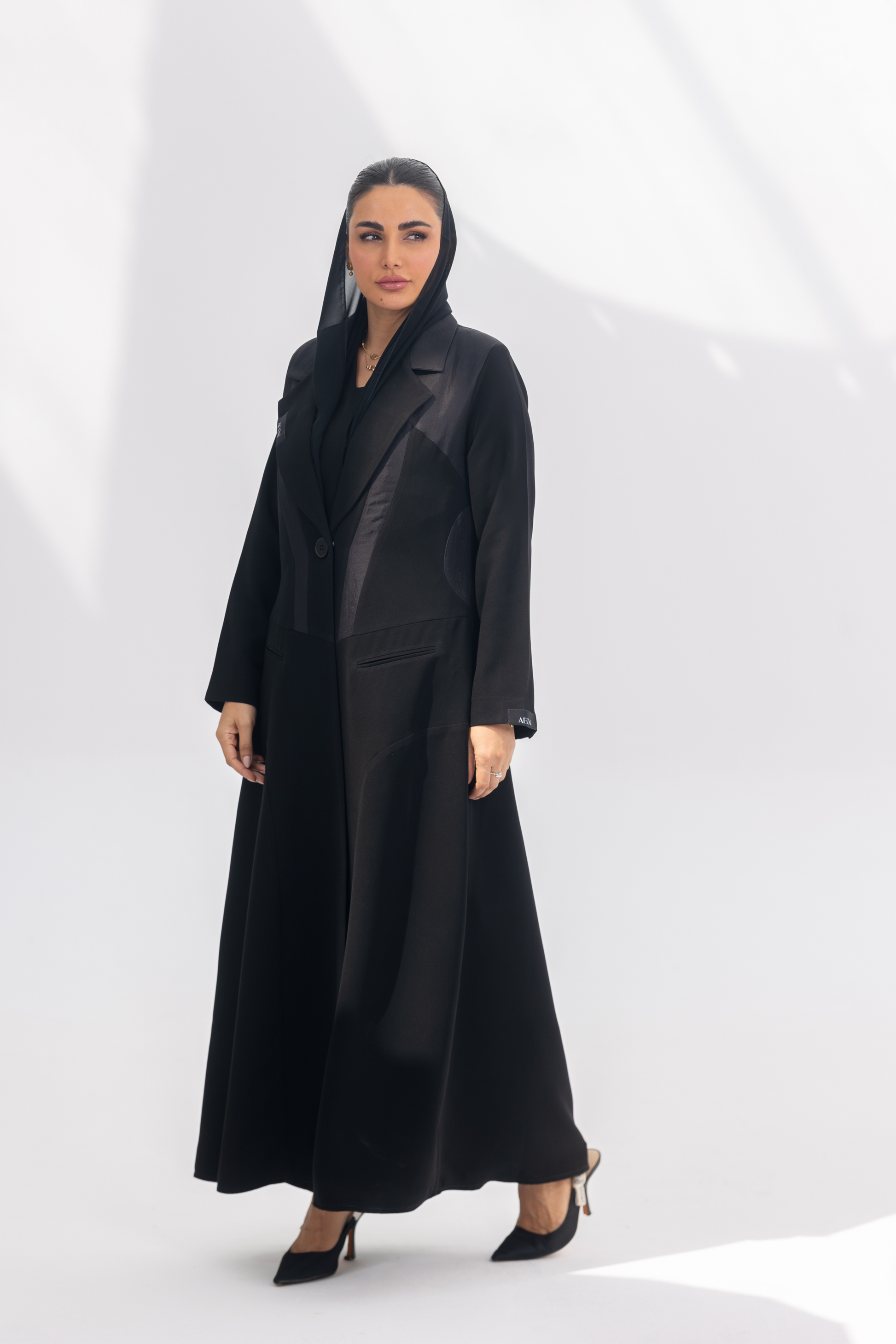 Woman wearing elegant black Jetline crepe abaya with dark grey accents and silk lining