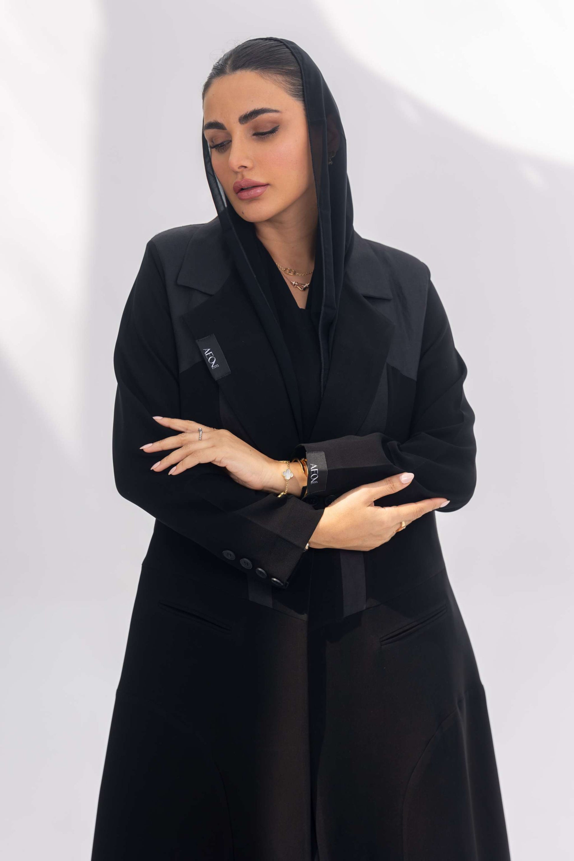 Woman wearing elegant black crepe Jetline abaya with dark grey accents and soft silk lining
