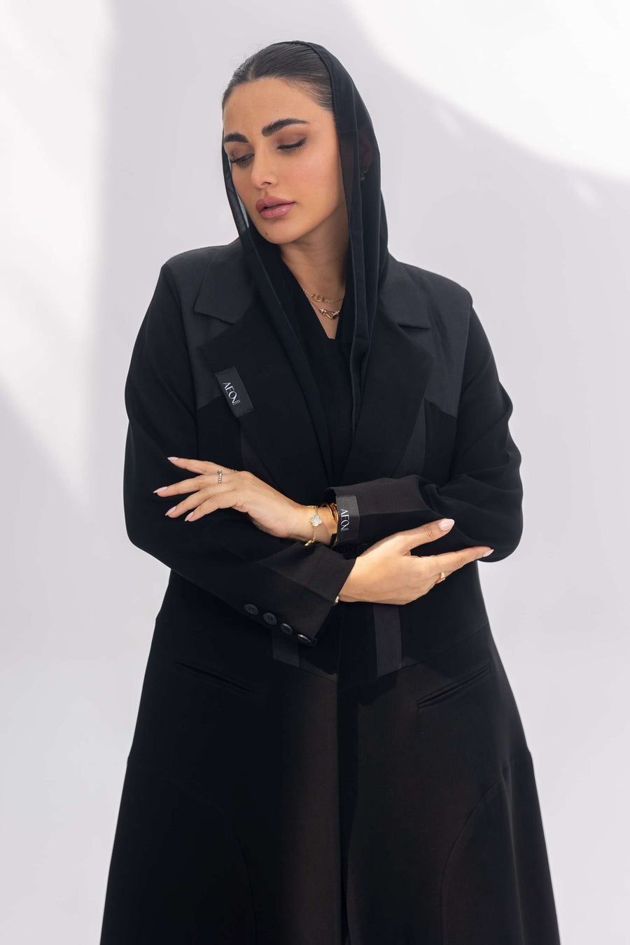 Woman wearing elegant black crepe Jetline abaya with dark grey accents and soft silk lining