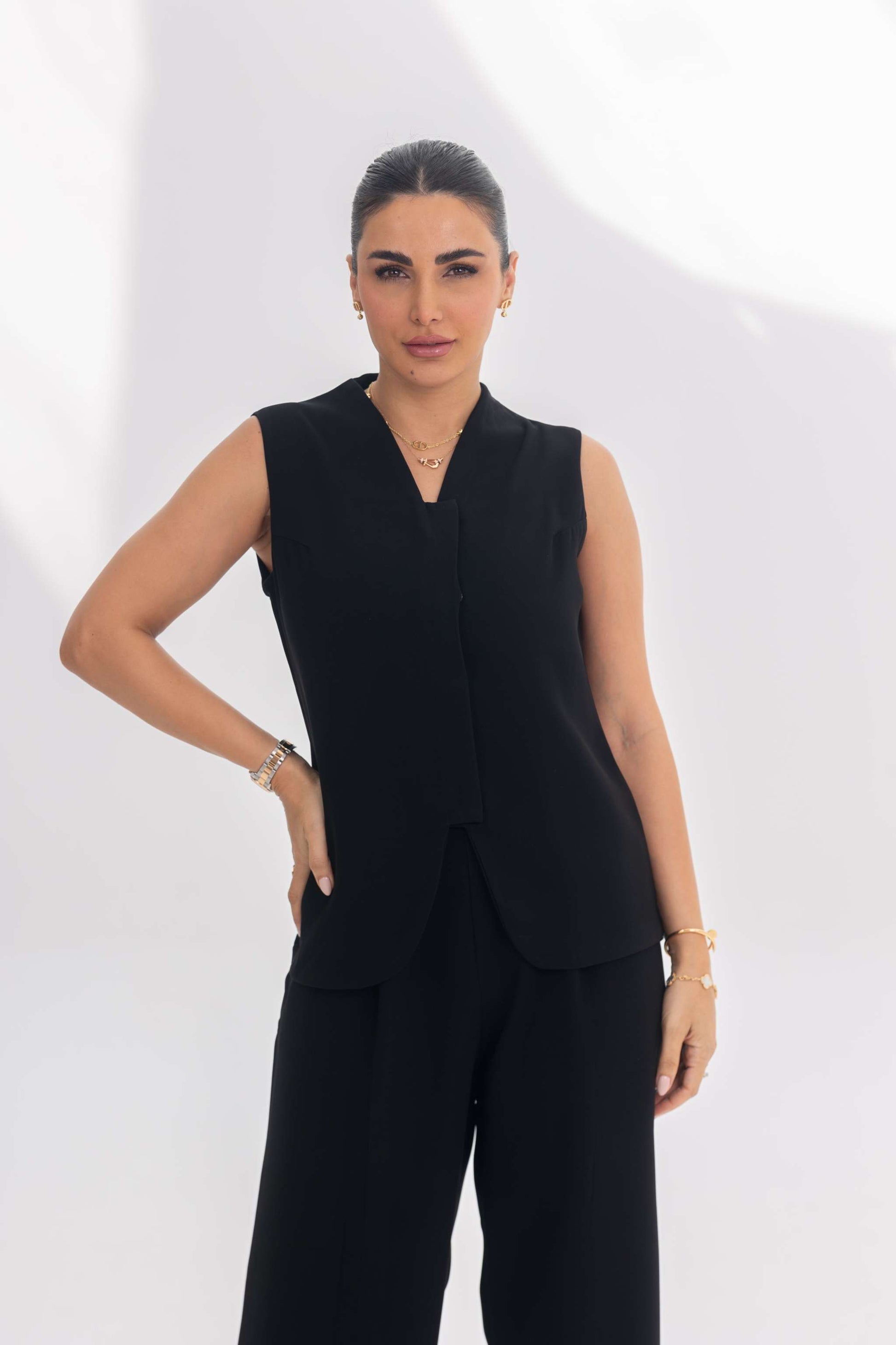 Woman wearing Noir Essesntial black sleeveless crepe inner set with minimalist design and fluid silhouette