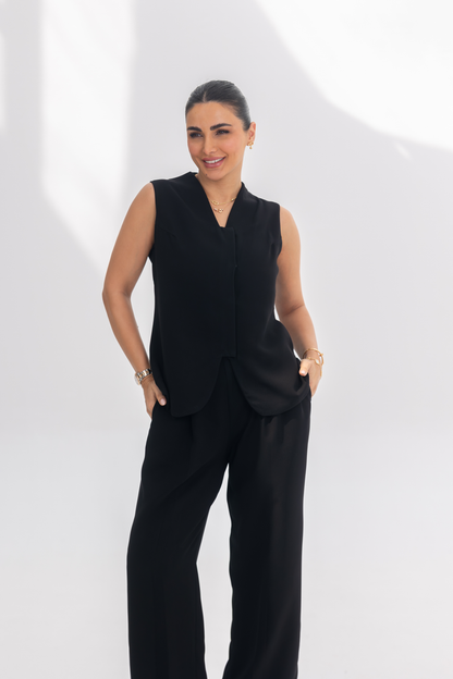 Woman wearing Noir Essential black sleeveless crepe inner set with fluid silhouette and minimalist design.