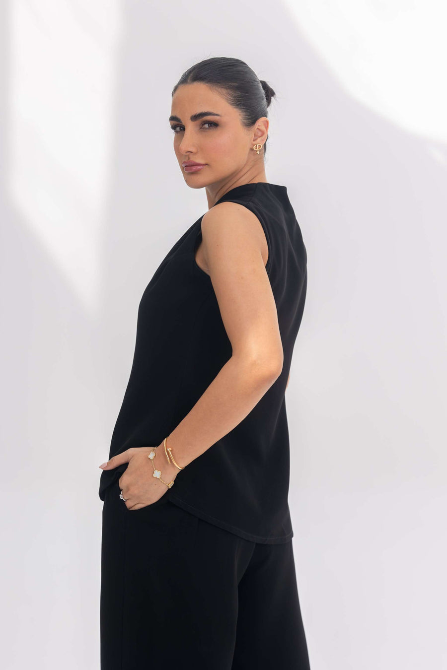 Woman wearing Noir Essential plain black crepe sleeveless inner set with minimalist design and elegant fit