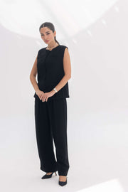 Woman wearing black crepe inner set with unique embroidery, styled for a sleek silhouette and comfort.