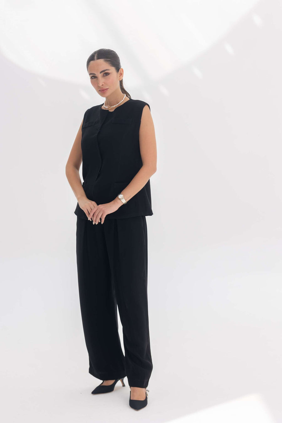 Woman wearing black crepe inner set with unique embroidery, styled for a sleek silhouette and comfort.