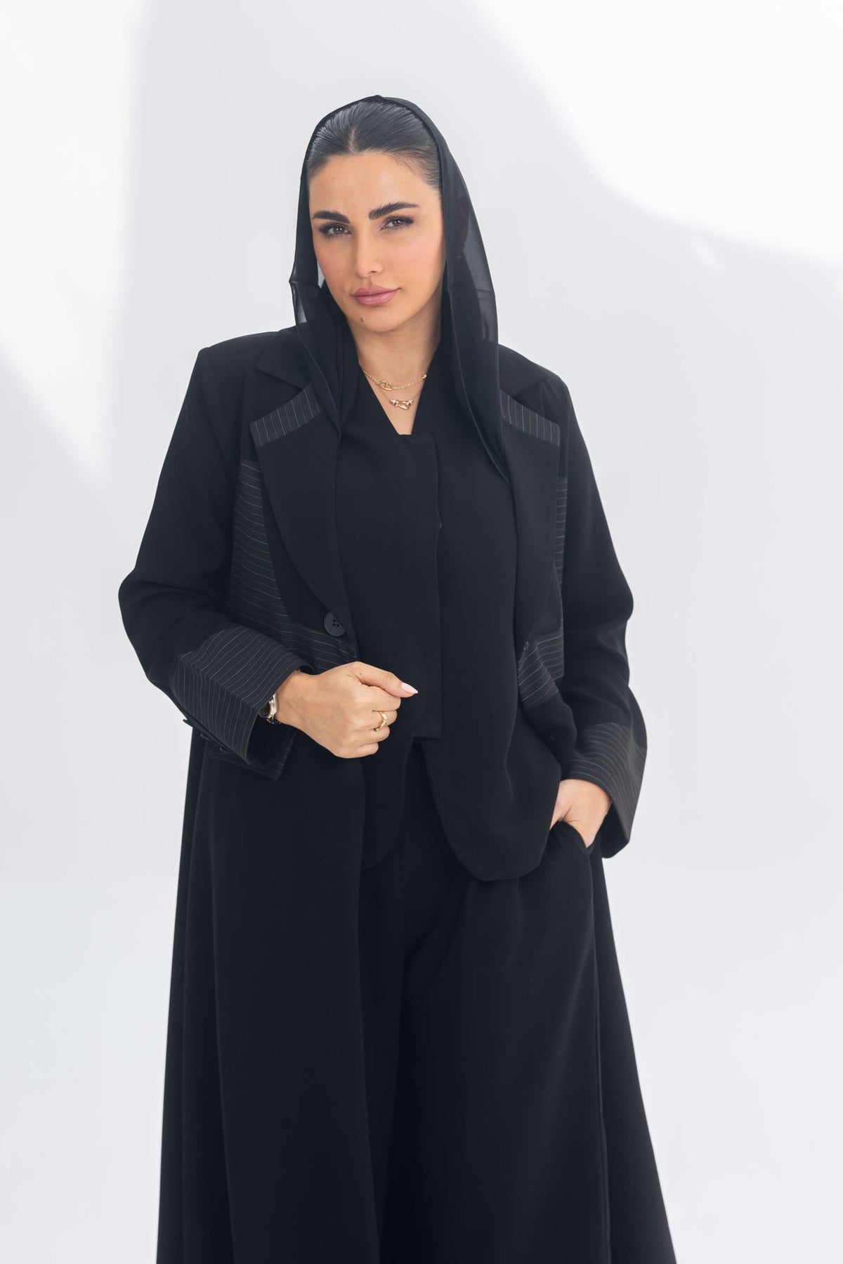 Black crepe blazer abaya with contrasting fabric detail, elegant and modern silhouette for formal and daily wear.