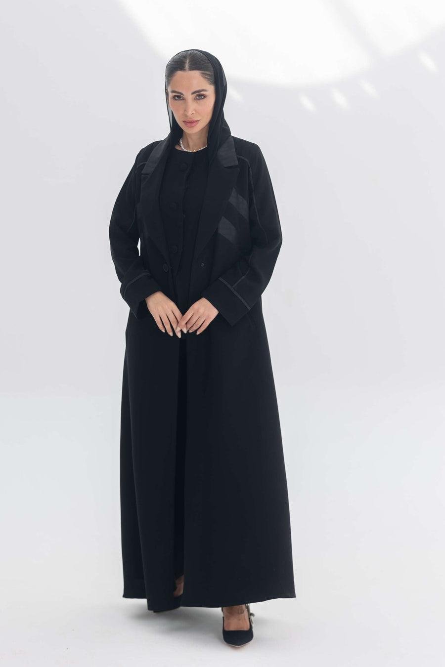 Noira Belle black crepe abaya with striped satin panels and modern design details for elegant style