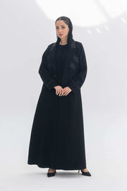 Noira Belle black crepe abaya with striped satin panels and modern elegant design