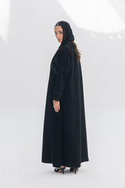 Noira Belle black crepe abaya with striped satin panels and modern elegant design
