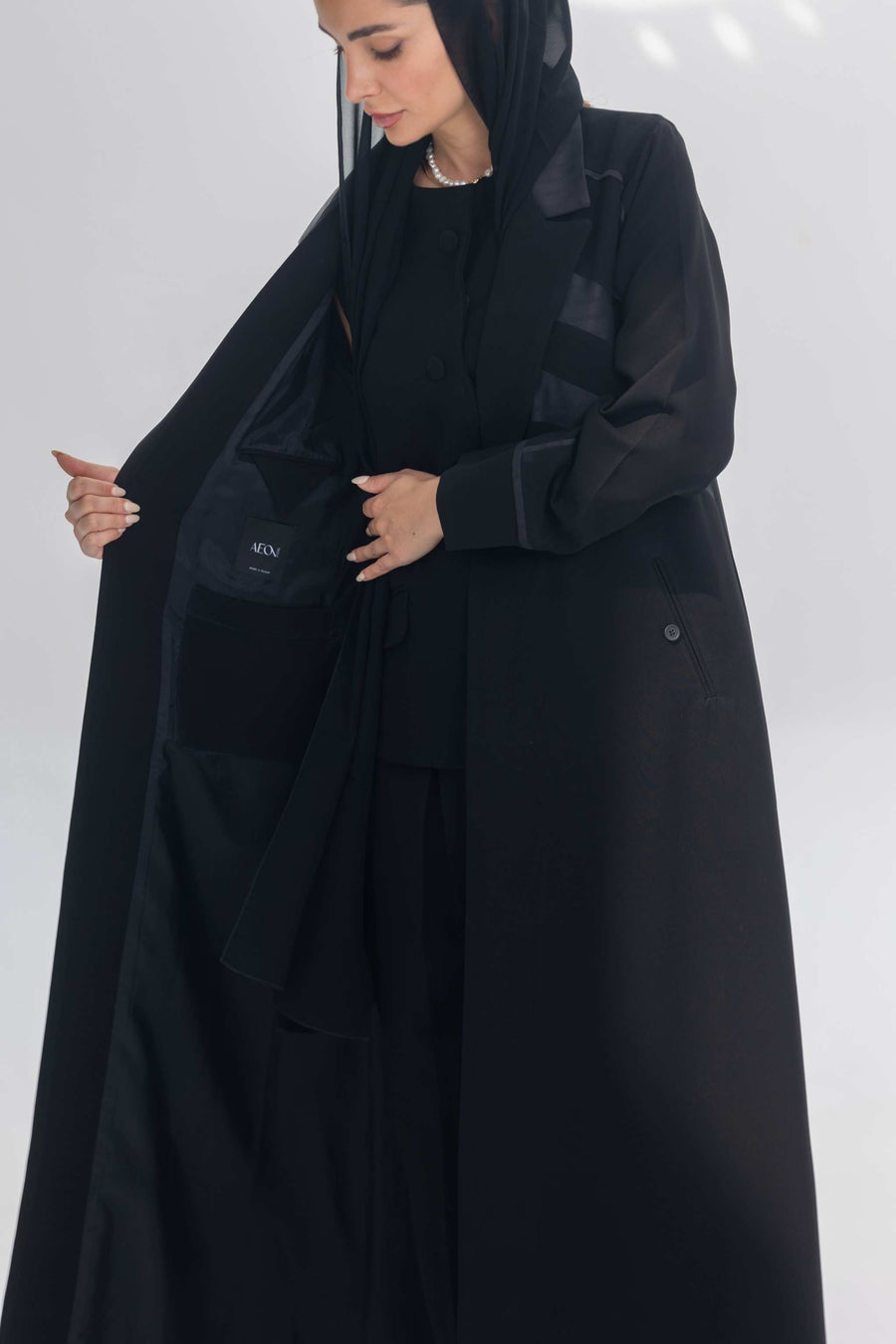 Noira Belle black crepe abaya with striped satin panels and modern elegant design