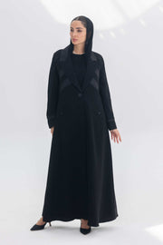 Noira Belle black crepe abaya with striped satin panels and modern silhouette