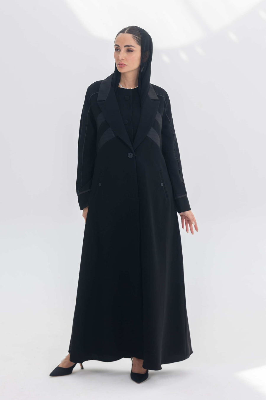 Noira Belle black crepe abaya with striped satin panels and modern silhouette