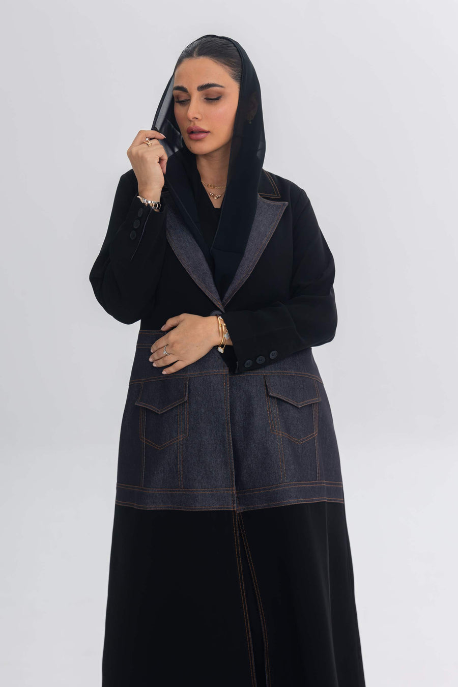 Woman wearing Blue Stitch black crepe and denim fusion abaya with modern, chic design