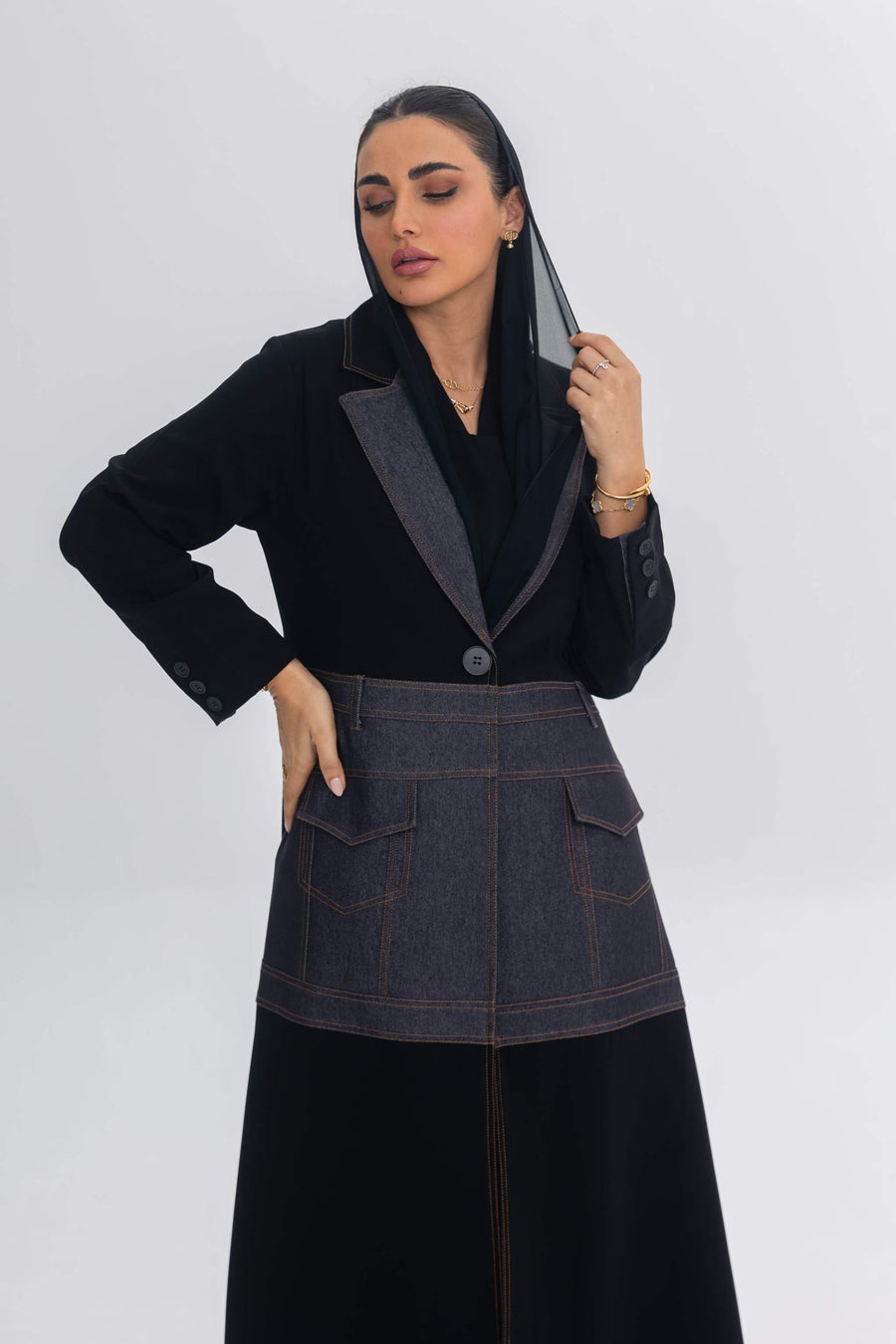 Woman wearing Blue Stitch abaya with black crepe and denim fabric fusion design