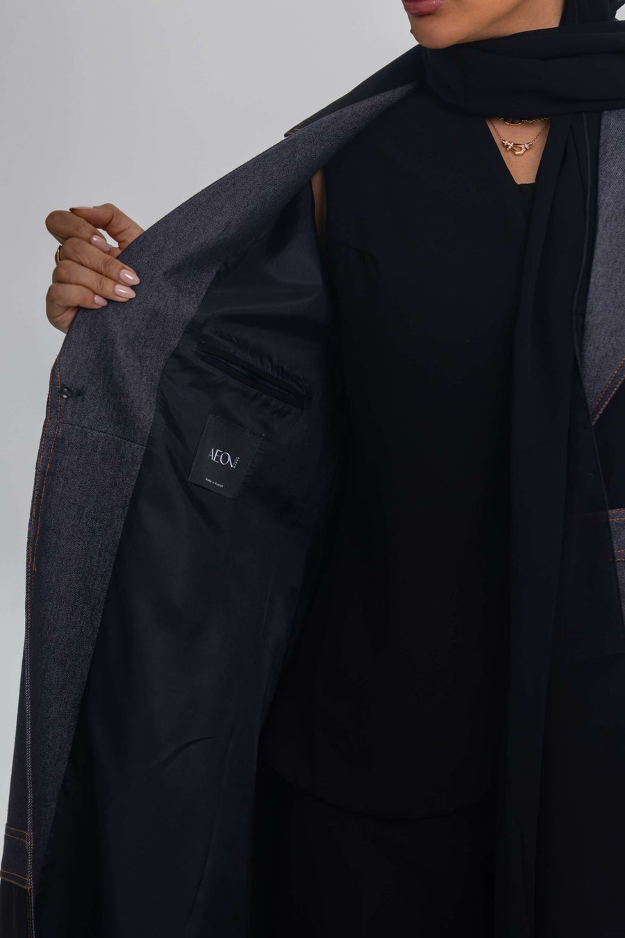 Black crepe abaya with denim fabric detail showcasing Blue Stitch design and modern elegance