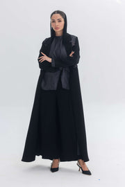 Woman wearing a black crepe abaya with denim accents called Denim Veil, blending modern edge with classic elegance.