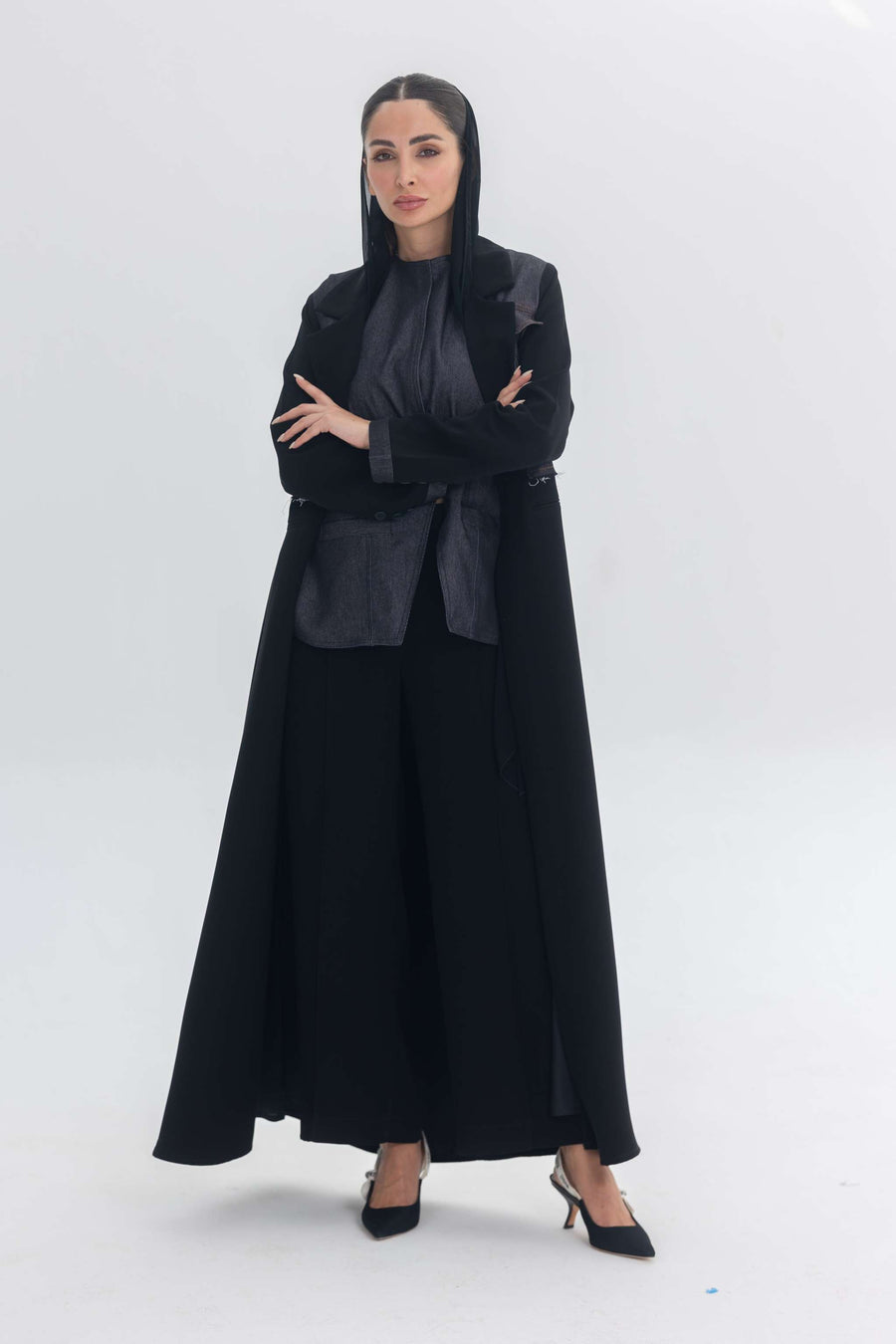 Woman wearing a black crepe abaya with denim accents called Denim Veil, blending modern edge with classic elegance.