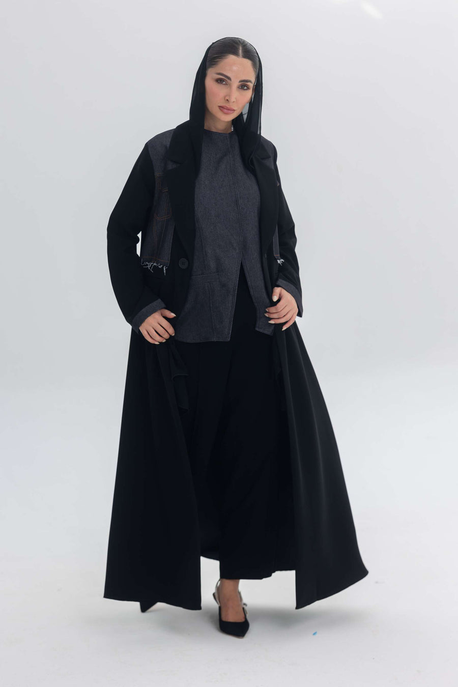 Woman wearing a black crepe abaya with denim accents called Denim Veil, styled for a modern and elegant look.