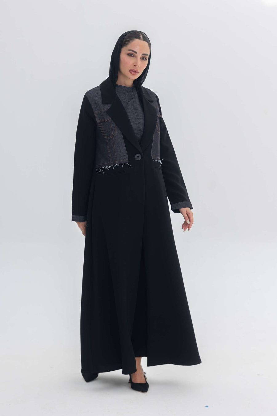 Woman wearing a black crepe abaya with denim accents called Denim Veil, blending modern edge and classic elegance.