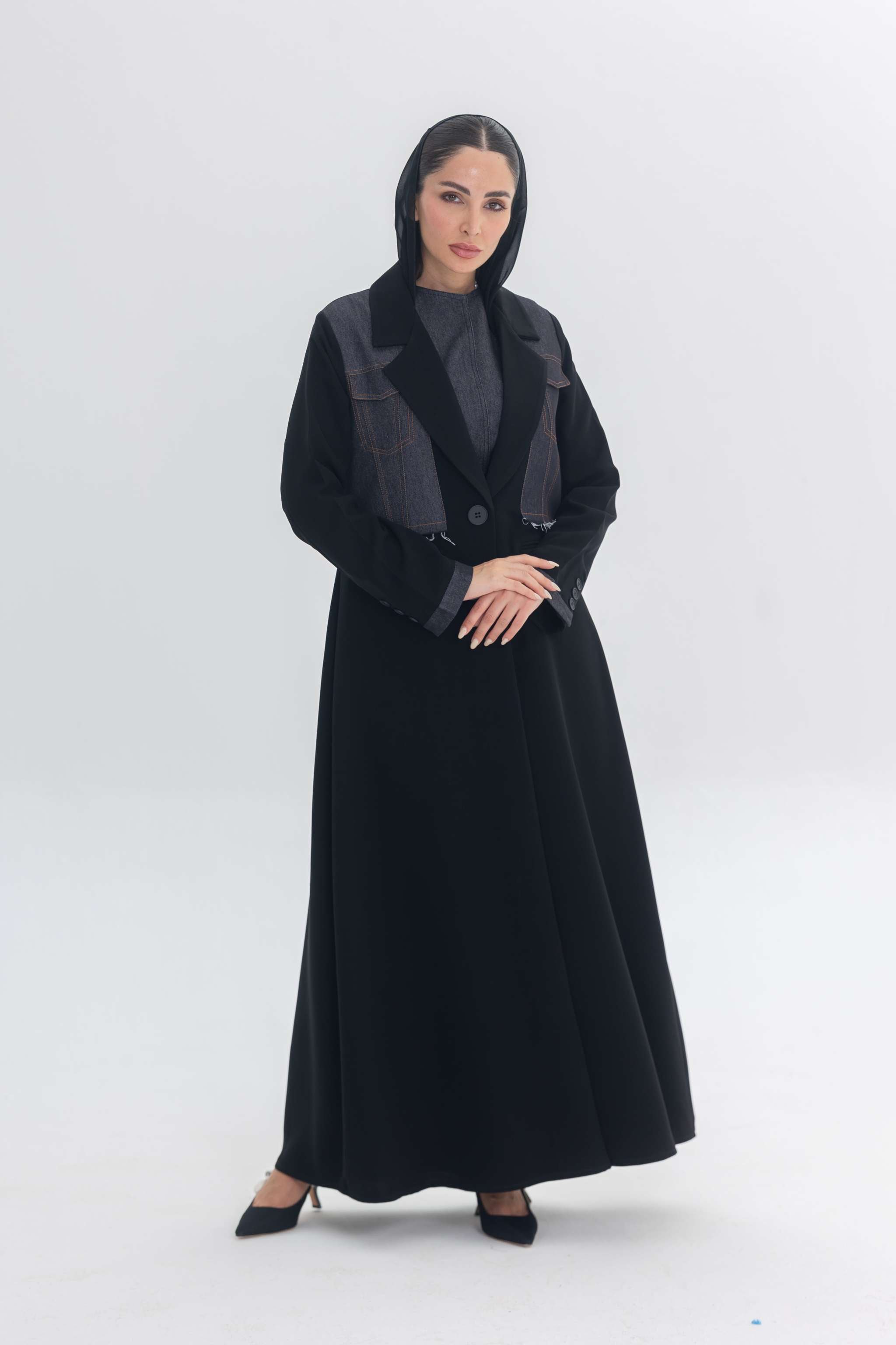 Woman wearing black crepe abaya with denim accents called Denim Veil, blending modern edge and classic elegance.