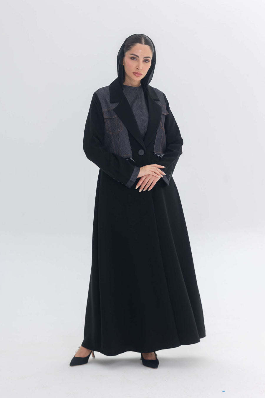 Woman wearing black crepe abaya with denim accents called Denim Veil, blending modern edge and classic elegance.