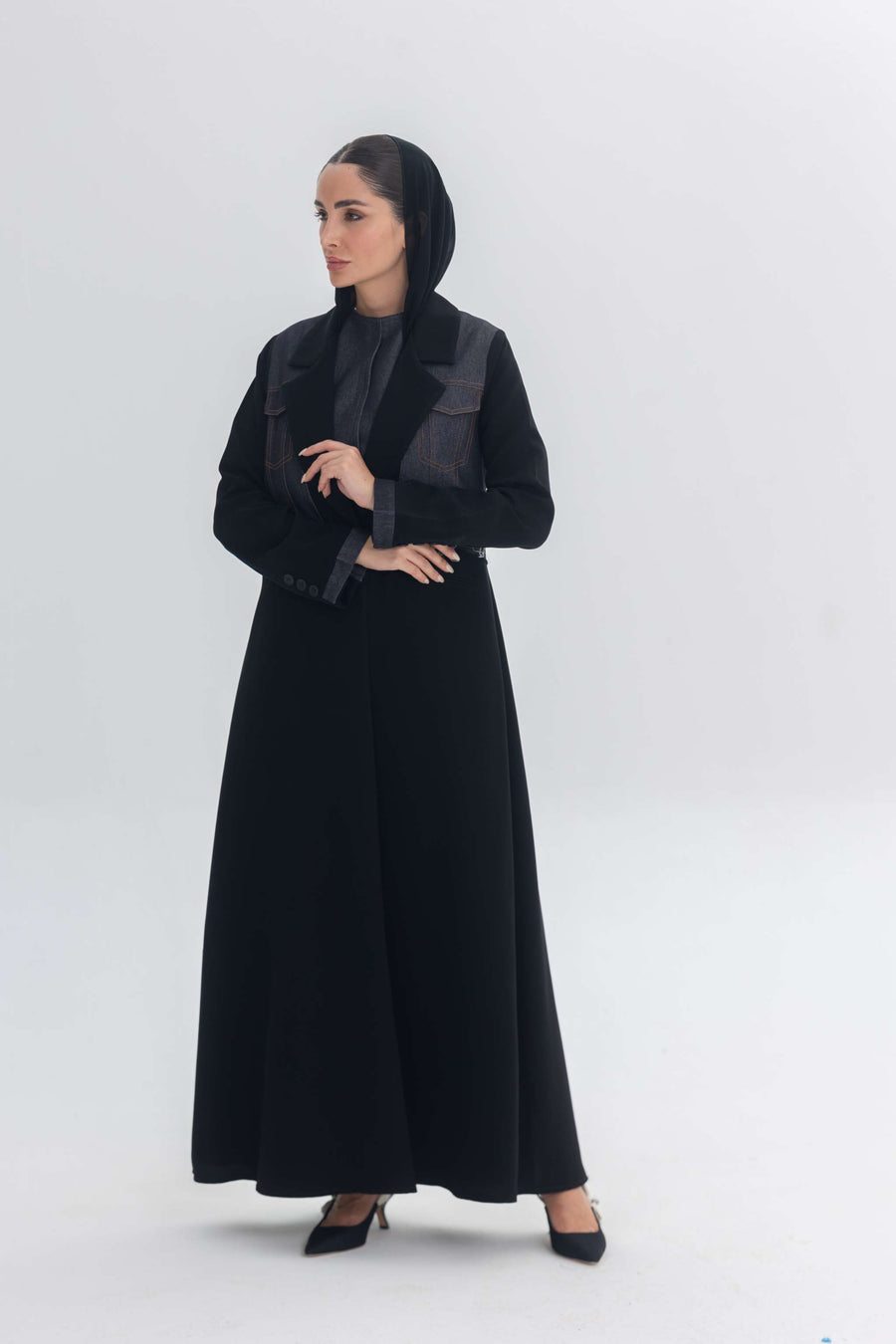 Woman wearing black crepe abaya with distinctive denim accents called Denim Veil