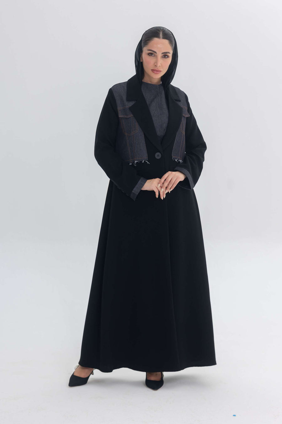 Woman wearing black crepe abaya with denim accents named Denim Veil, blending modern edge and classic elegance.