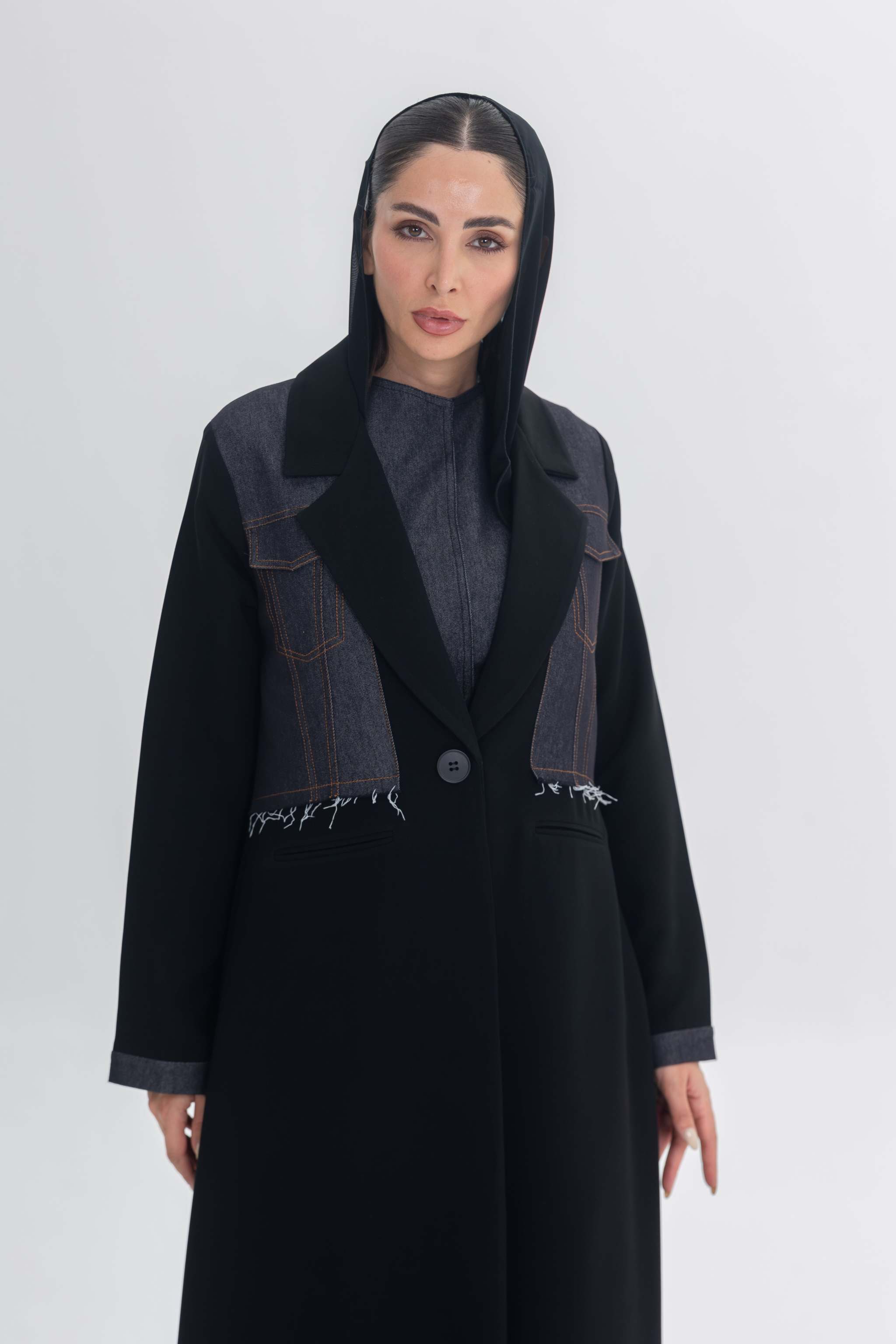 Woman wearing black crepe abaya with denim accents called Denim Veil, blending modern edge and classic elegance.