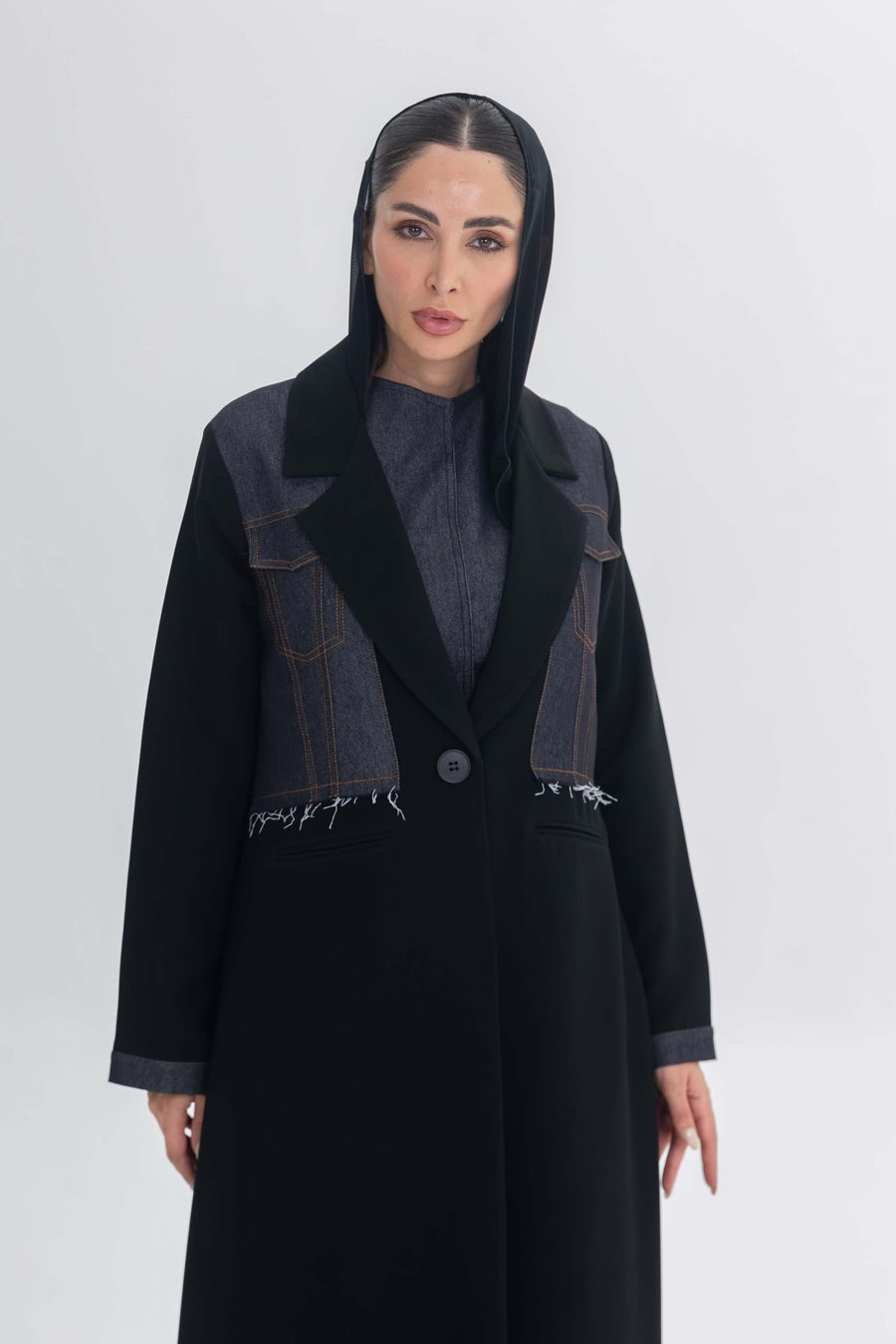 Woman wearing black crepe abaya with denim accents called Denim Veil, blending modern edge and classic elegance.
