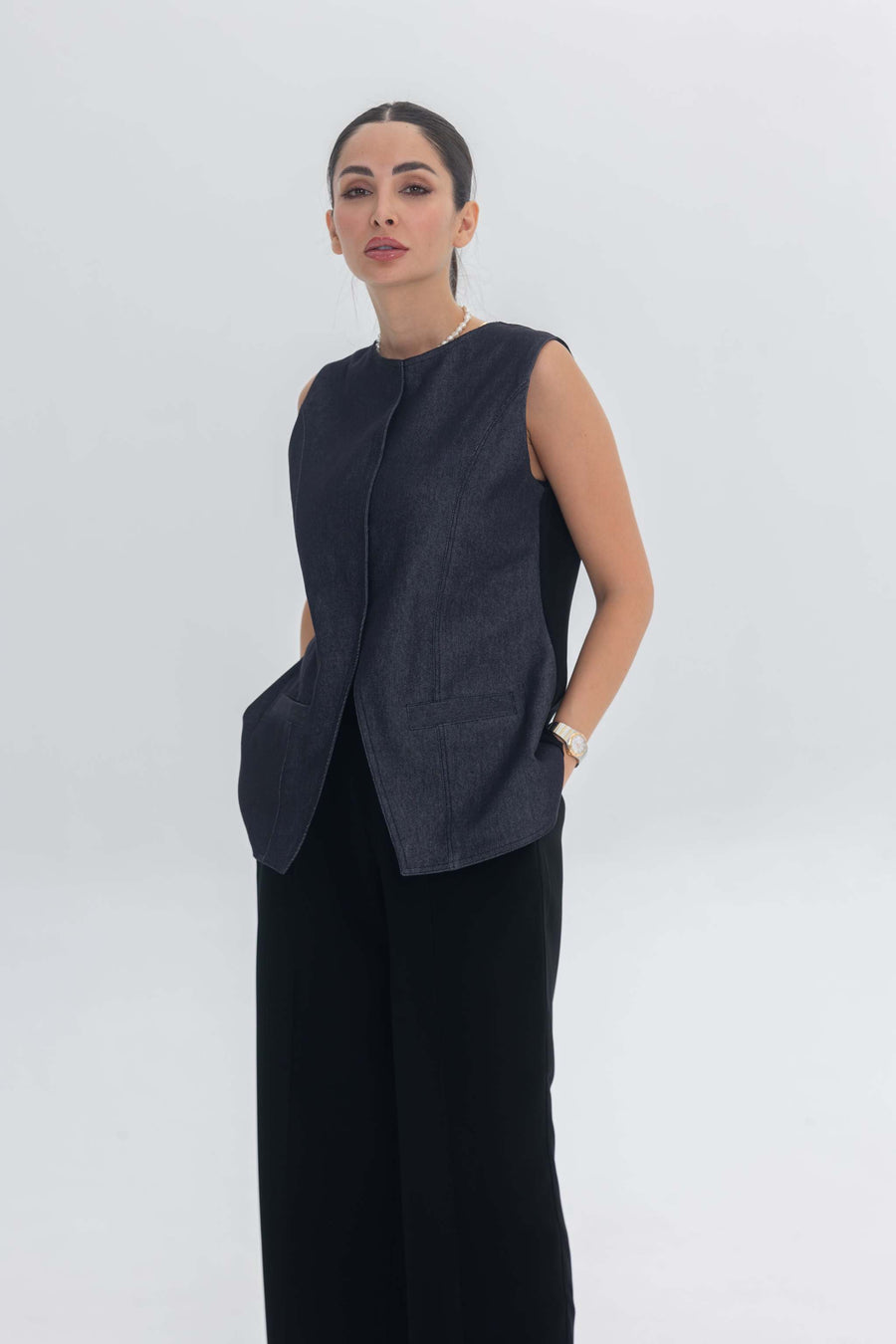 Woman wearing True Bleu sleeveless denim top and black crepe pants set
