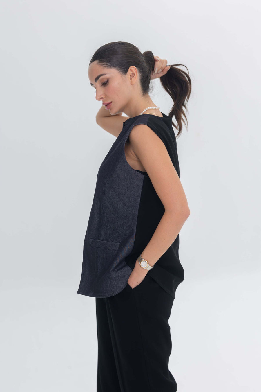 Woman wearing True Bleu denim top and black crepe pants inner set standing in profile against white background