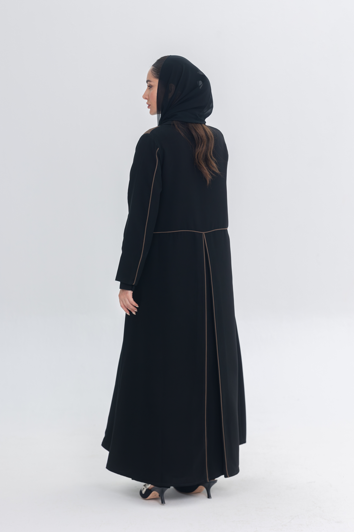 Black abaya with rich brown Cocoa Shadow detailing creating a 3D effect and elegant silhouette.