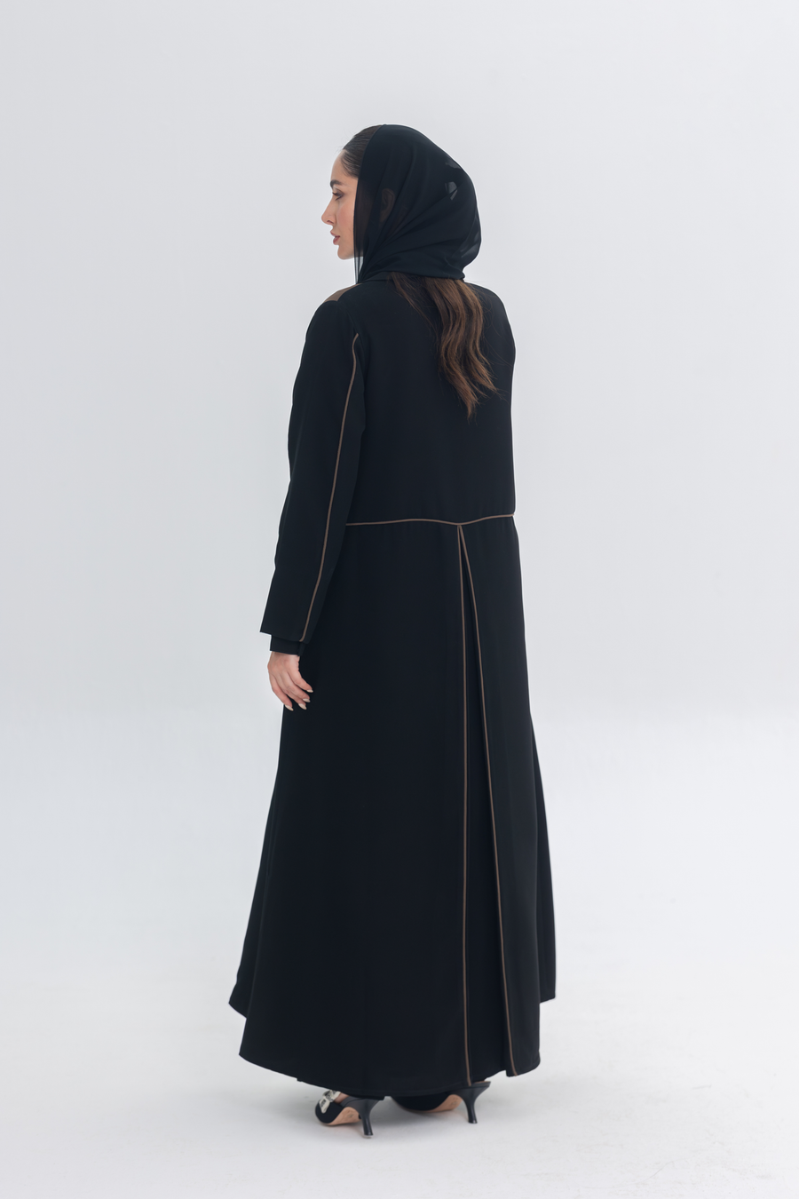 Black abaya with rich brown Cocoa Shadow detailing creating a 3D effect and elegant silhouette.