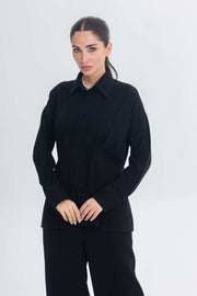 Woman wearing Essense Folds black chic and modest inner set with sleek silhouette and button-up design