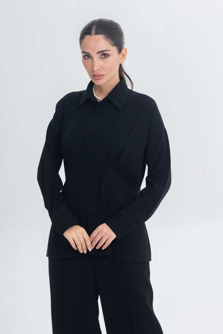 Woman wearing Essense Folds black chic and modest inner set with sleek silhouette and button-up design