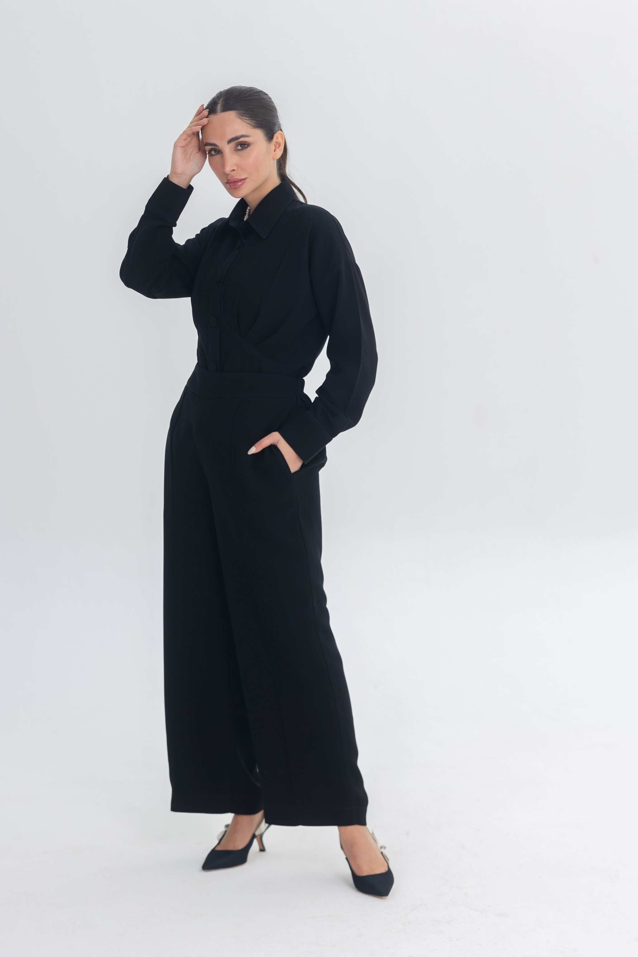 Woman wearing Essense Folds black chic inner set with sleek silhouette and long sleeves