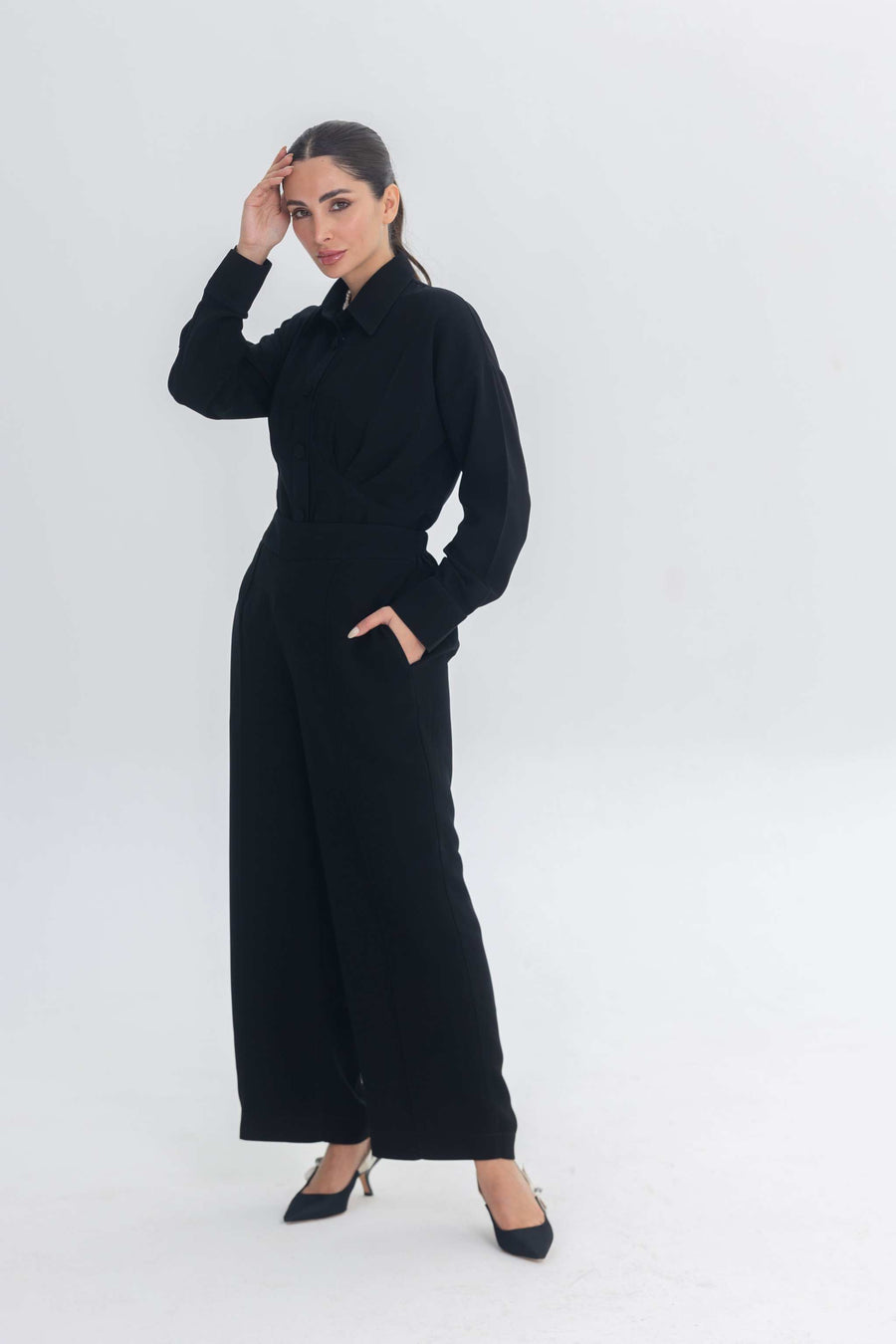 Woman wearing Essense Folds black chic inner set with sleek silhouette and long sleeves