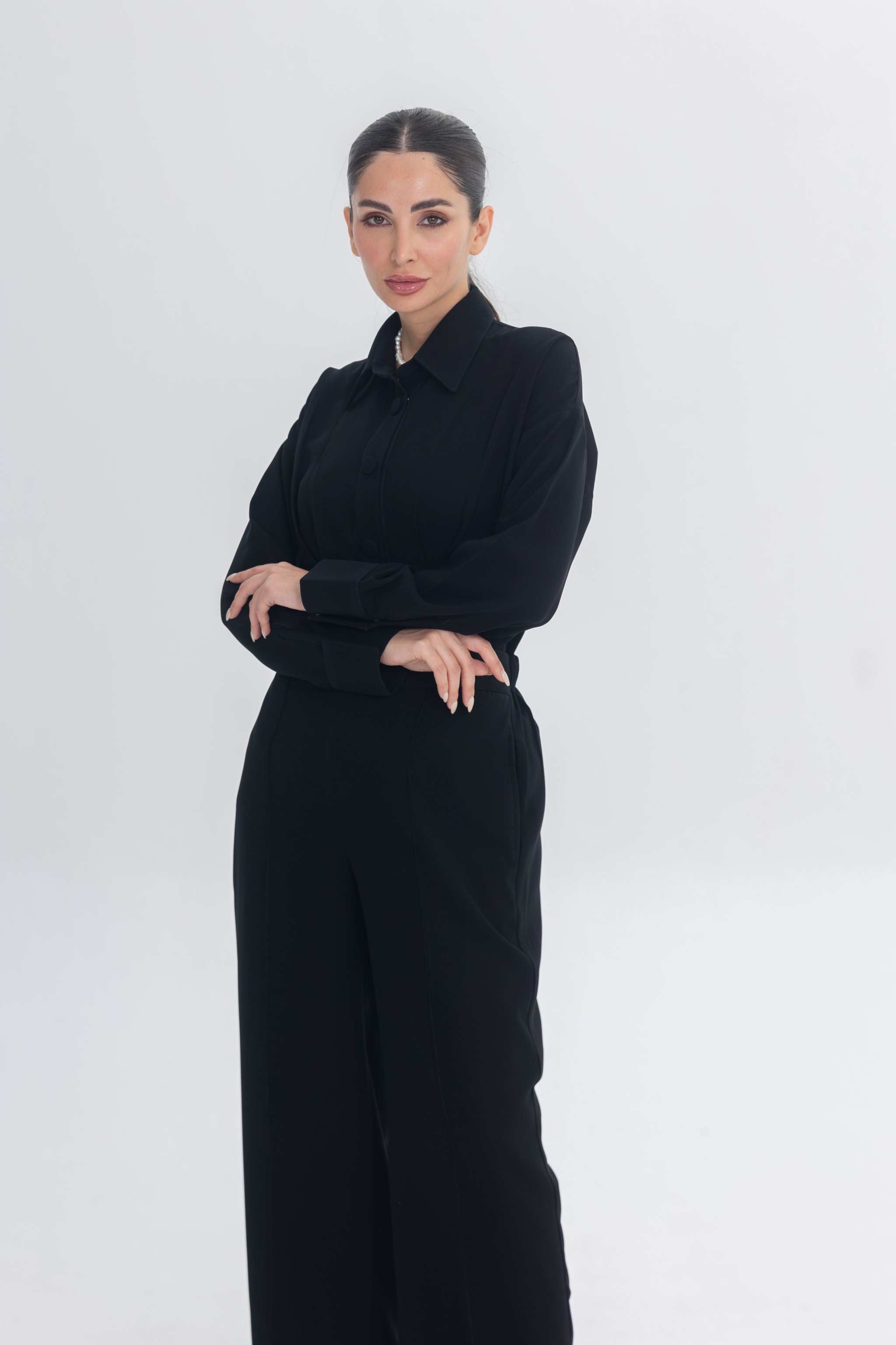 Woman wearing Essense Folds black chic and modest inner set for layering under abaya